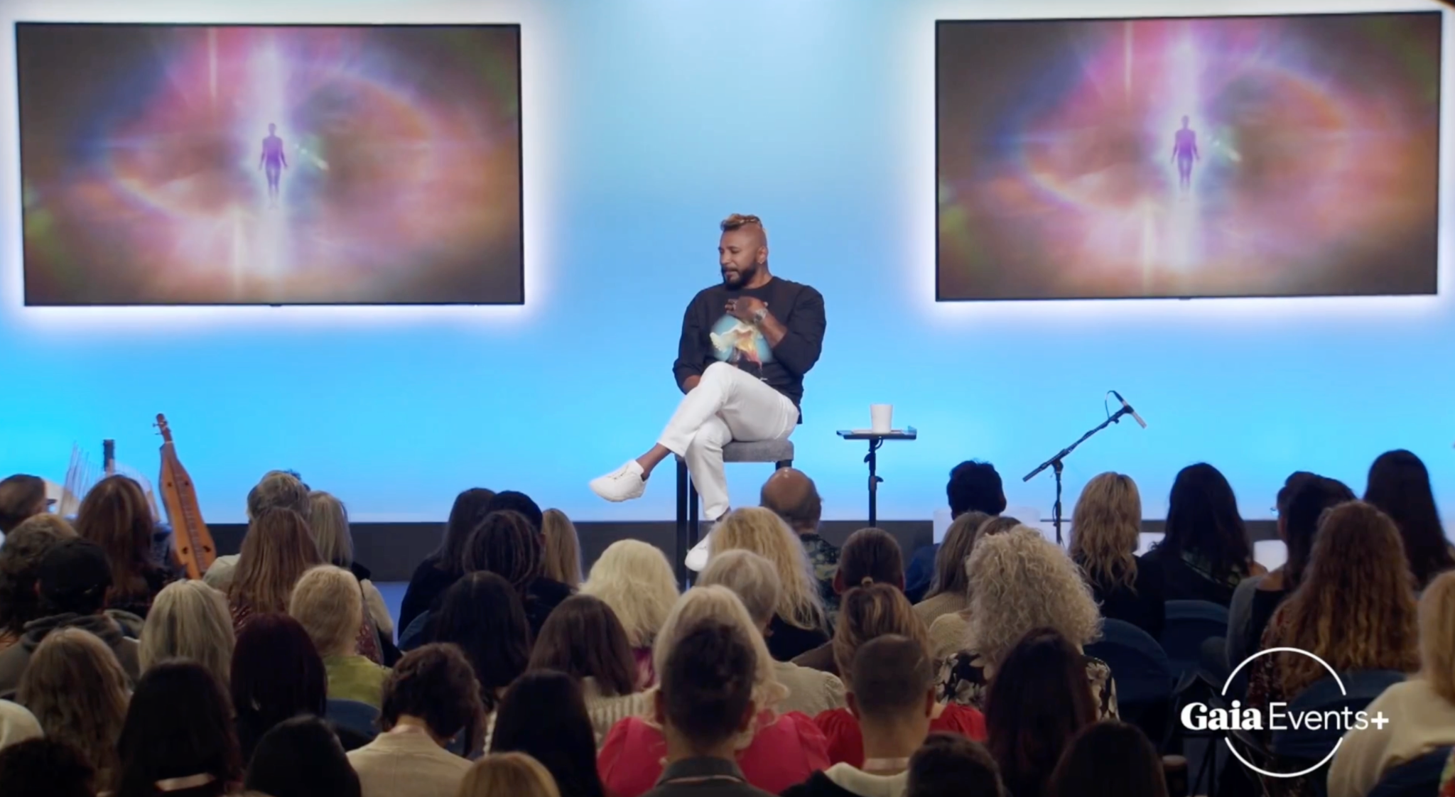 Riz Mirza speaking to an audience at a Gaia event